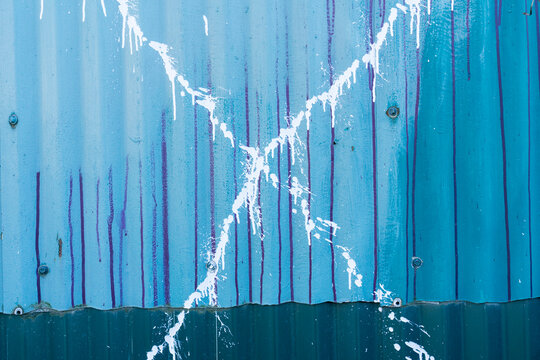 Splattered paint and graffiti on warehouse wall