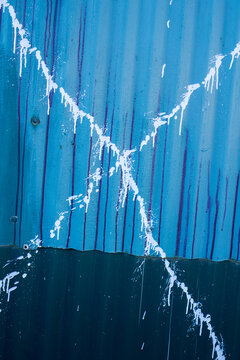 Splattered paint and graffiti on warehouse wall