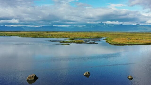 Aerial view of Avacha river delta and hilly landscape, Kamchatka Peninsula, Russia, 4k