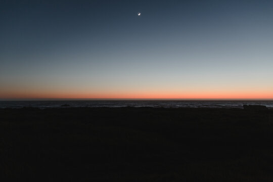 Crescent moon twilight over the Pacific Ocean