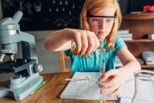 Red haired girl doing an experiment in a science class