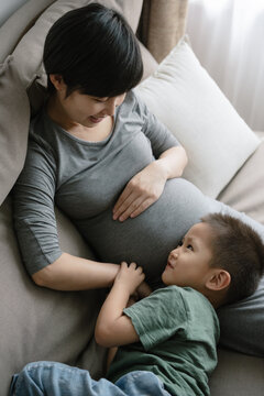 Boy with pregnant mother at home