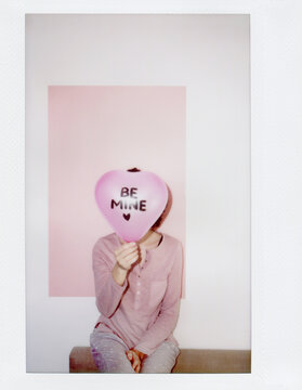 Woman posing with Be Mine balloon
