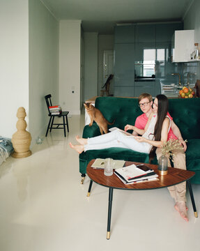 Couple sitting on sofa at home