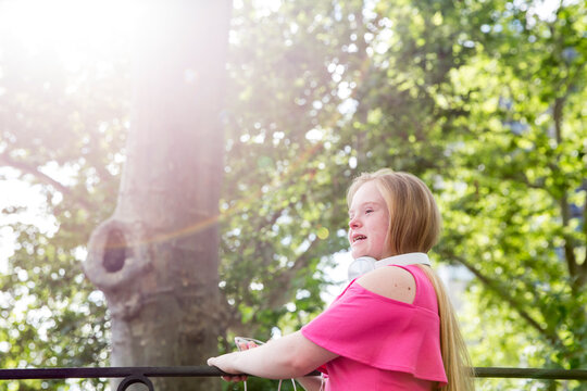 Girl with down syndrome in a pink top.