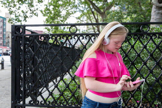 Girl with down syndrome listening to music.
