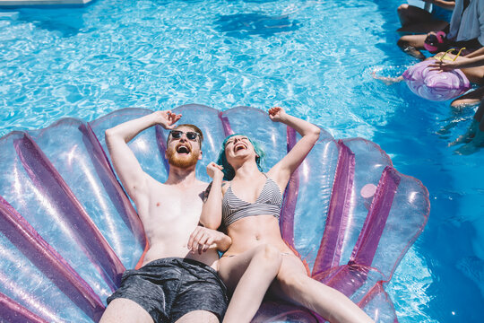 Group of friends having fun in the pool