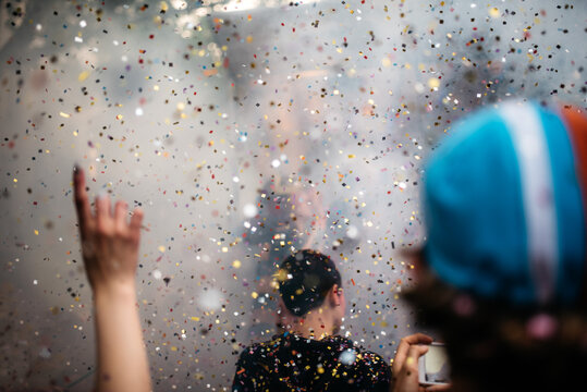 Protesters dancing through smoke and confetti