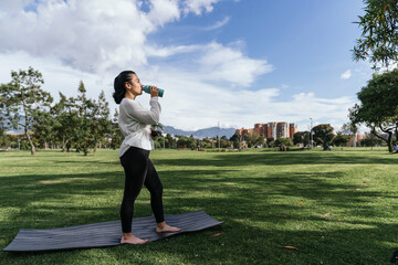 Fototapeta premium Woman doing yoga outdoors at a park