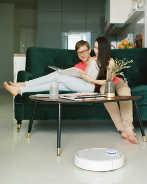 Couple watching magazine in living room