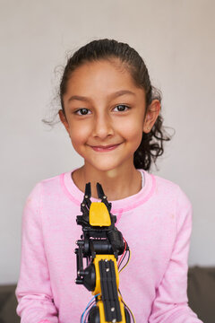 Young school girl with a programmable robot in a science project