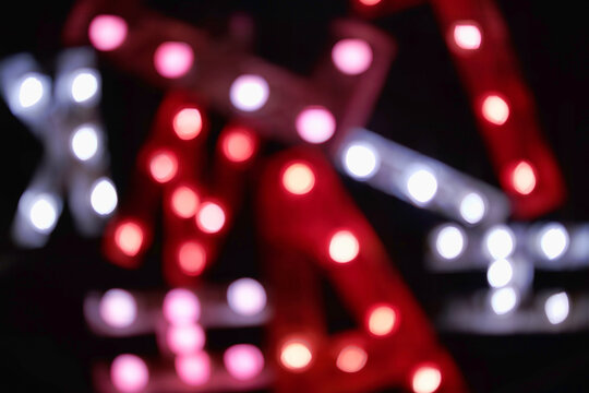 Bokeh blur of colored lights on a wall at night