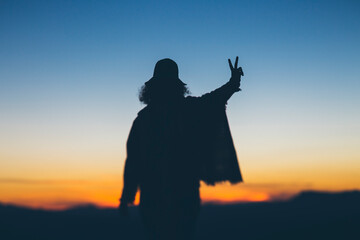Woman contemplating a sunset