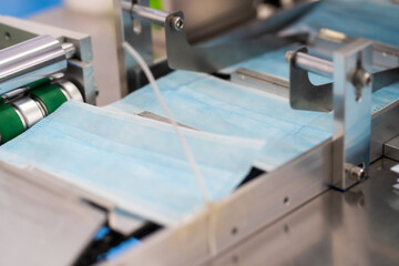 Machines are working for producing masks in a sterile factory. Production of medical masks. process of manufacturing a mask