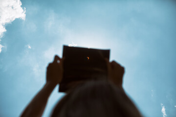 Eclipse: Girl Looks Up As Moon Moves Across Sun