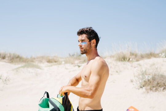 Confident man putting parachute