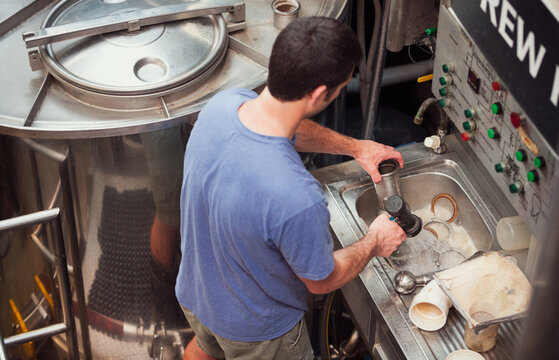 Beer: Brewer Cleans Equipment In Sink By Mash Tun