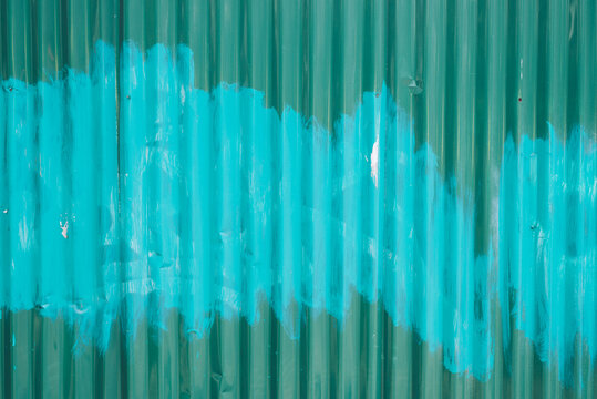 Messy Paint All Over Corrugated Green Metal Wall