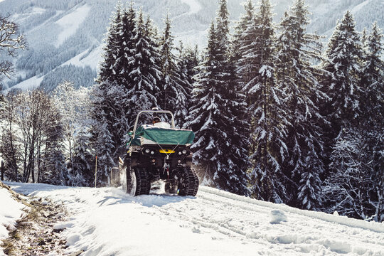 Off road vehicle climbing up snowy mountains
