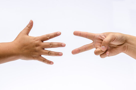 Close up of two hands show paper hand and paper hand playing in rock paper scissors game, Isolated on white background, place for text or sign.
