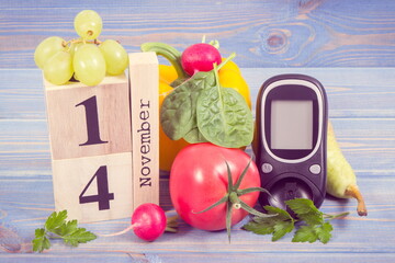 Date 14 November as symbol of world diabetes day, glucometer for measuring sugar level and fruits...