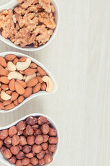 Various nuts and almonds, healthy nutrition and lifestyle, copy space for text or inscription