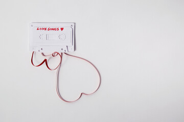 A white paper cassette tape with ""Love Songs ___"" written on it..