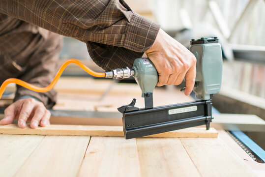Wood Working Man Using Nail Gun