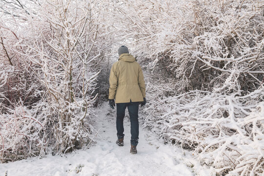 Man walking on snow covered path