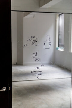 Wide view of glazing schematics drawn on glass panel with marker pen