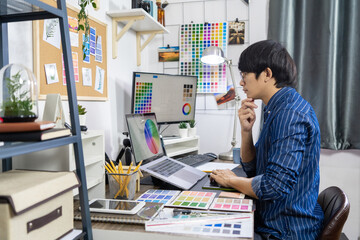 Asian Designer or creative Occupation Design Studio artist working on graphic computer at the office using graphics tablet and a stylus, Illustrator Graphic Skill Concept.