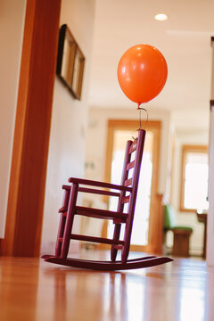 Someone attached an Orange Balloon to my Rocking Chair