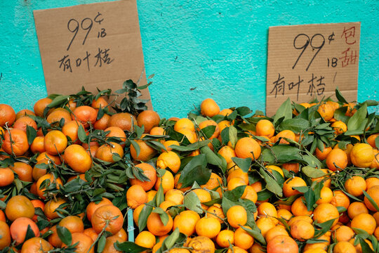 Piles of oranges at an outdoor store.