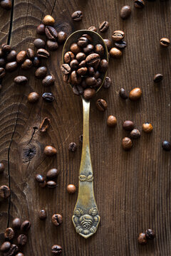 Roasted coffee beans on vintage spoon