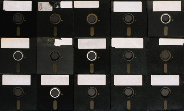 A bunch of old floppy disks all arranged neatly.