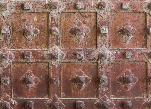 Closeup of wrought iron metal work on old oak door of church