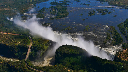 Stunning aerial panorama view of the majestic and powerful Victoria Falls (largest waterfall...
