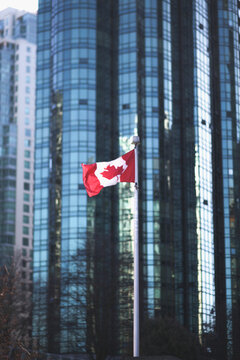 Canada flag against skyscrapers