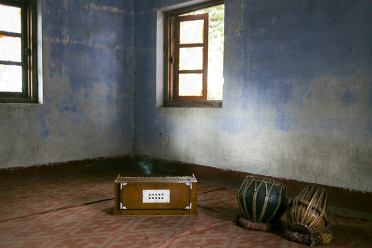 Harmonium and tabla inside a classroom.
