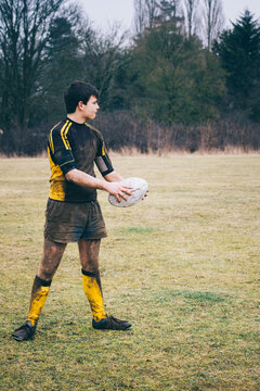 Muddy teenage rugby player