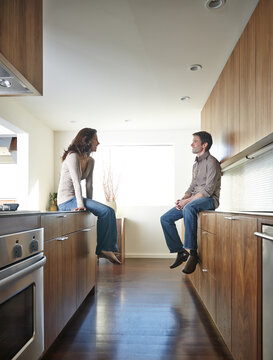 Couple relaxing in kitchen together.