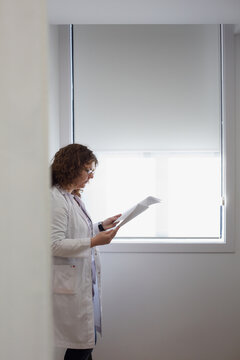 Female doctor examining a medical report