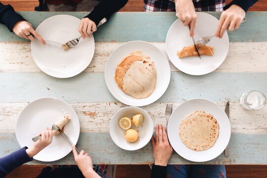 Overhead image of a family sharing pancakes