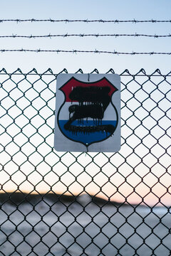 Government no trespassing sign on barbed wire fence