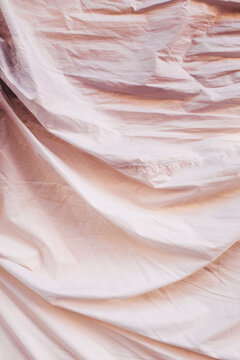 Fold and wrinkles of pink cotton sheet