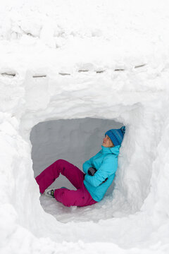 Young woman sitting inside a igloo