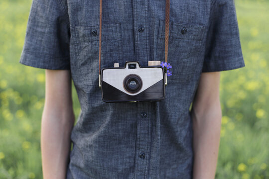 Young man with vintage camera