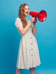 Beautiful girl holds the red megaphone in hand