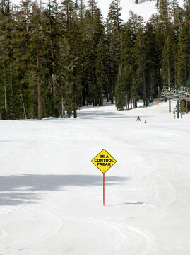 Sign in the snow saying Be a Control Freak