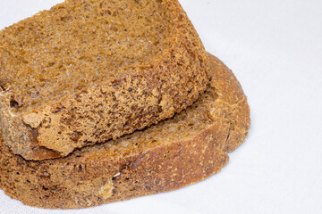 Two slices of black crusty bread.